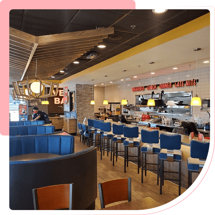 A restaurant with many chairs and tables in it