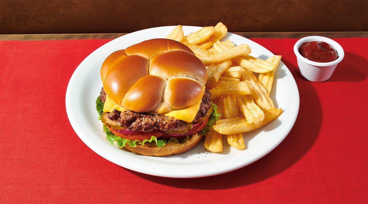 A hamburger and french fries on a plate.