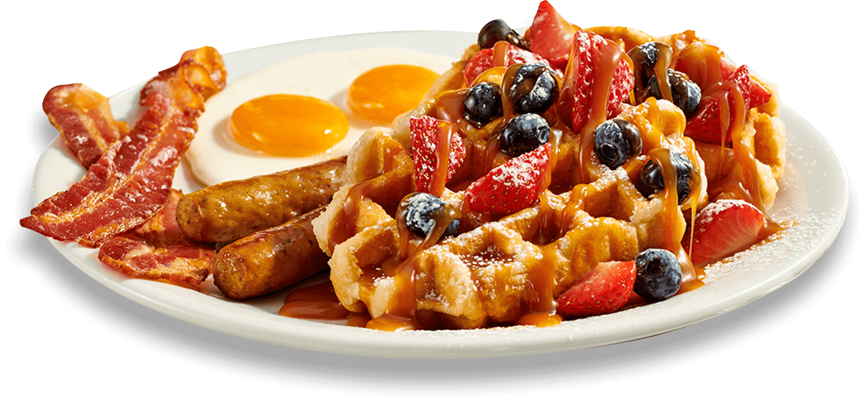 A plate of food with waffles, fruit and eggs.